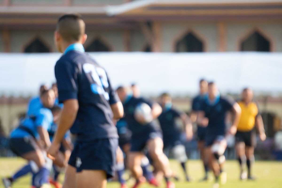 Blurred background image of school rugby game